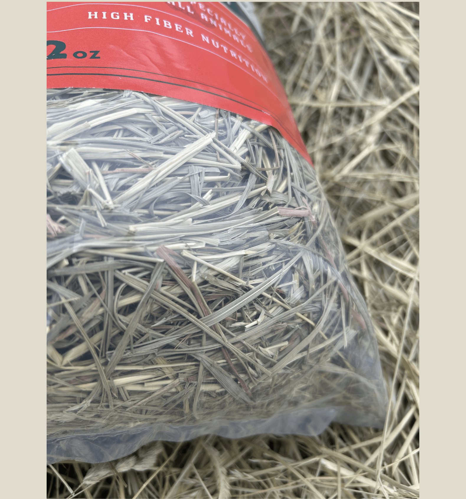 Bag of hay with a red label on a textured background