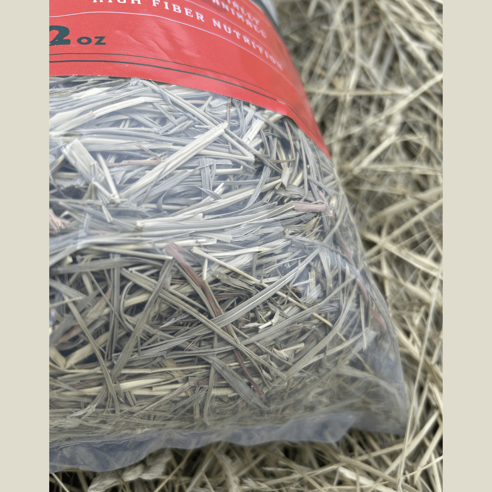 Bag of hay with a red label on a textured background