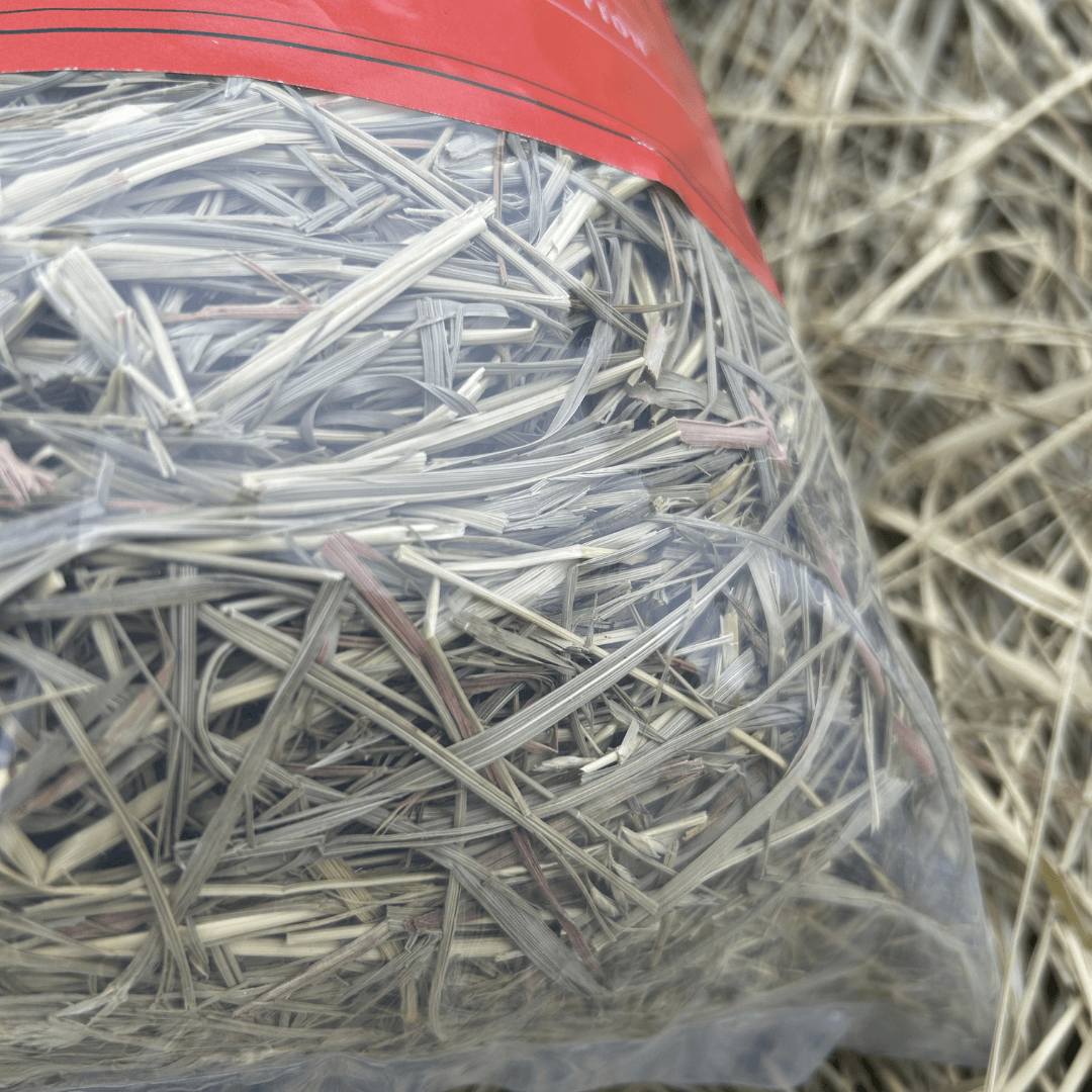 close up view of bell feed co hay packaged in a clear bag 